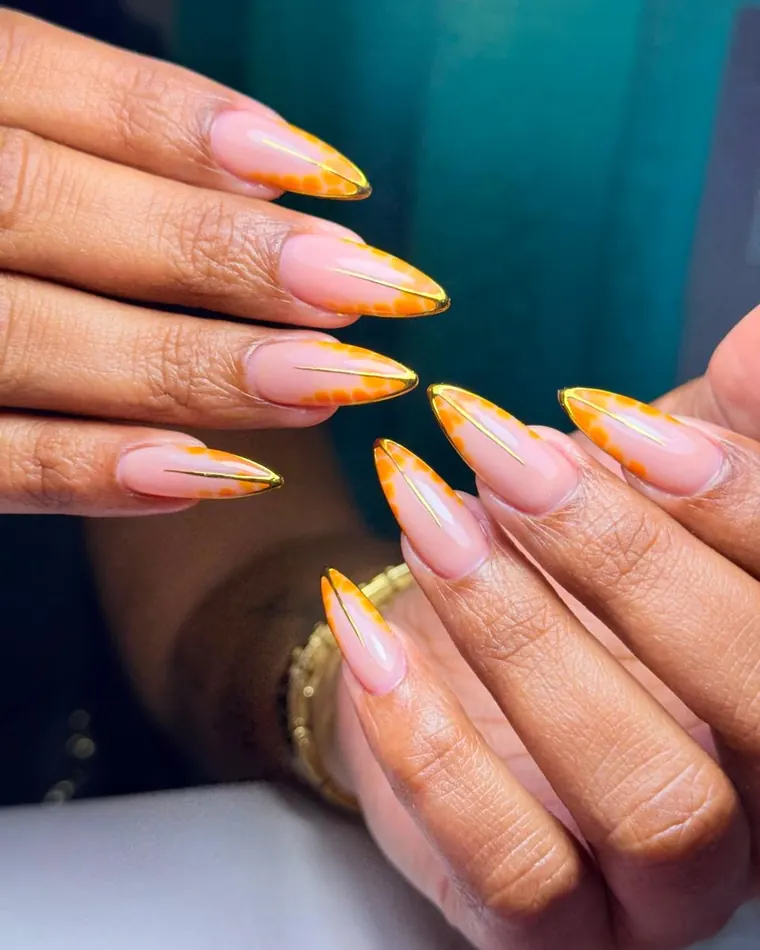 A finished set of stiletto extensions with a hand-painted accent.